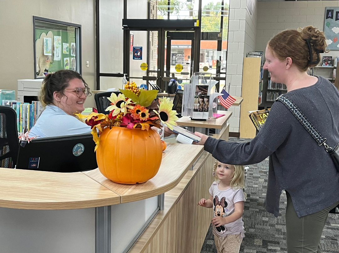 Woman checking out books